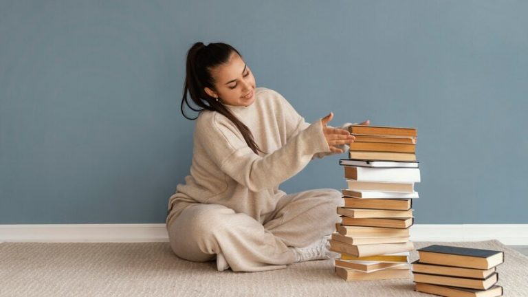 Girl with a pile of books